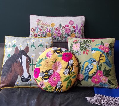 Rond kussen met handgeborduurde bloemen en bijen. Diameter 40cm.